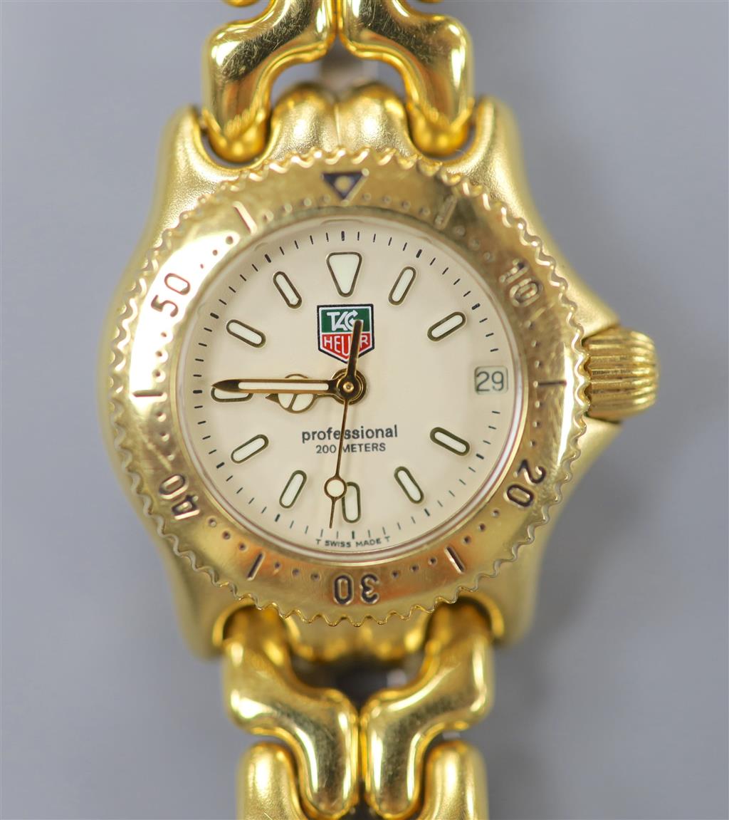 A ladys modern gilt steel Tag Heuer Professional quartz wrist watch, cased diameter 23mm, ex.crown.